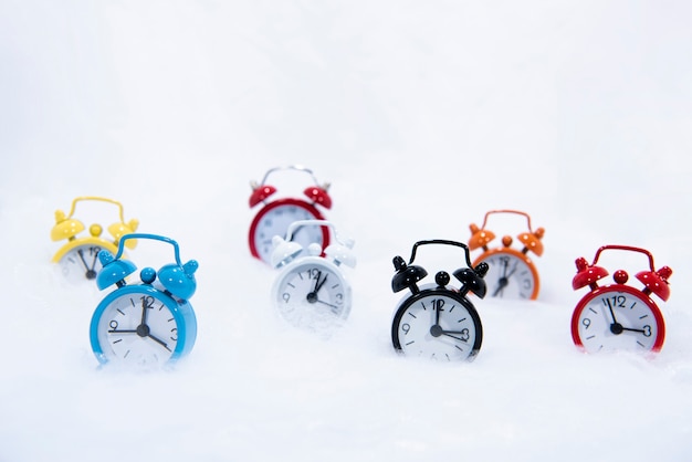 Alarm vintage small clocks with white winter snow