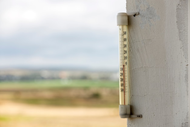 Alcohol glass thermometer Celsius outside on bright blurred light outdoors copy space