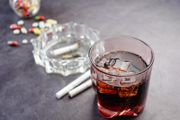 Alcohol pills and cigarette on table