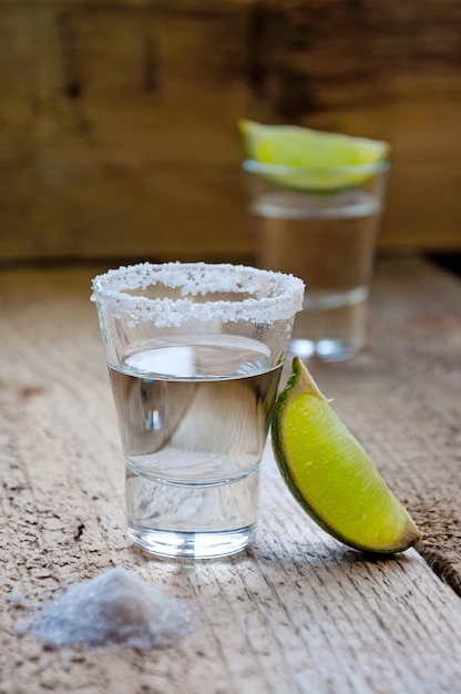 Alcohol Shot Drink. Silver Tequila with Lime and Salt on the Wooden Table