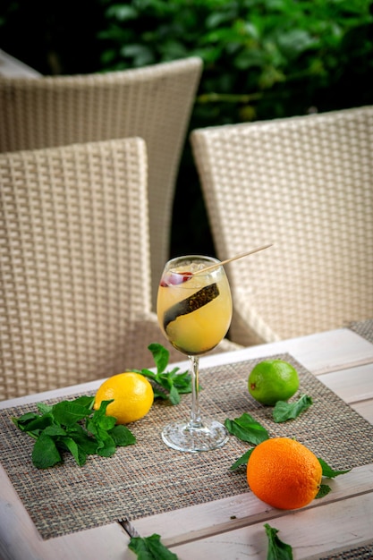 Alcoholic cocktail Orange gin tonic with fresh mint and lemon Beach refreshing cocktail at the bar