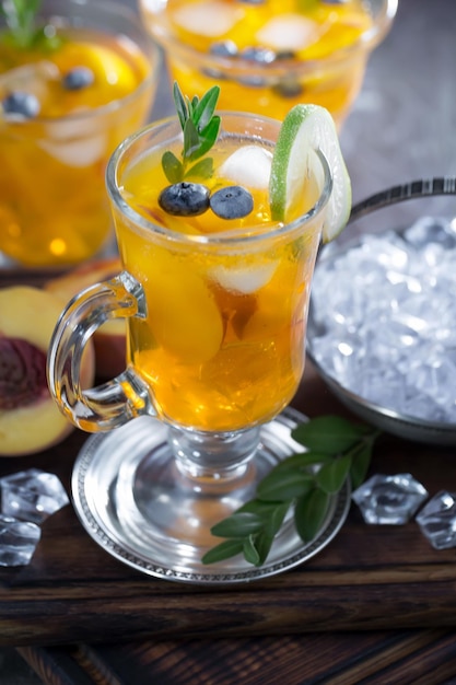 Alcoholic cocktail with fruit and ice