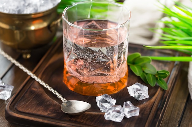 Alcoholic cocktail with fruit and ice