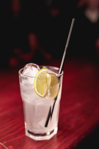 Alcoholic cocktail with lemon in a nightclub