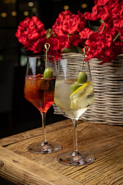 alcoholic cocktail with lemon and olive on a wooden table