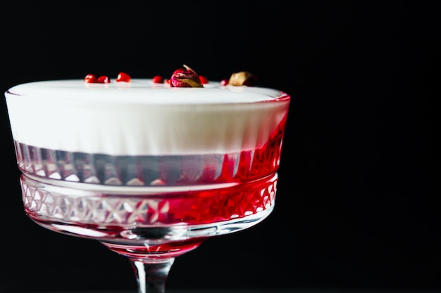 Alcoholic drink A cocktail with elite alcohol on dark black background closeup