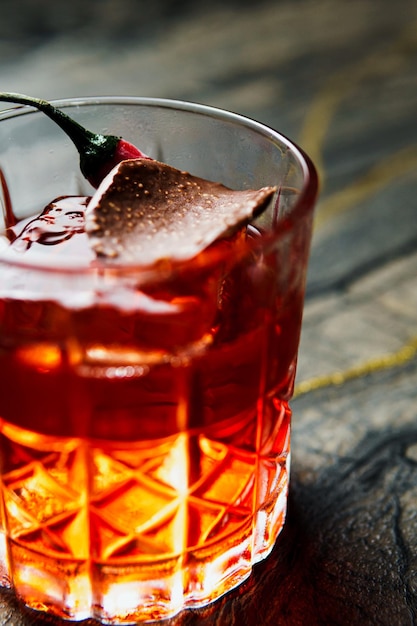 Alcoholic drink A cocktail with whiskey or cognac on the table closeup dark background