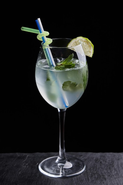 Alcoholic drinks at the bar. Bartender's hands in the process of making drinks.