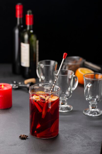 Alcoholic mulled wine with fruits and spices on a dark background traditional alcoholic drink Christmas