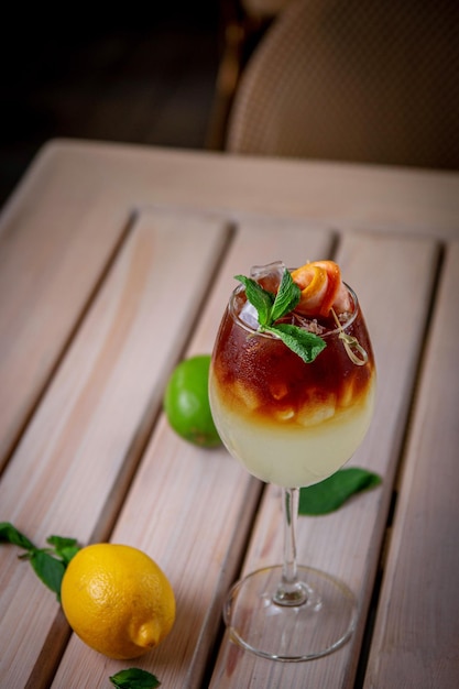 Alcoholic refreshing cocktail coffee ginger ale with tonic on the summer terrace of the restaurant