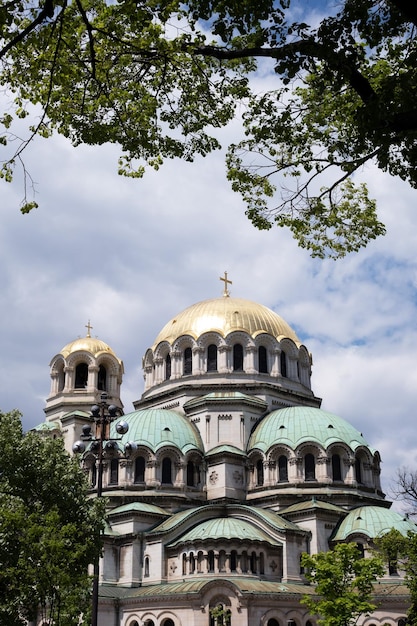 Alexander nevsky cathedral in sofia bulgaria beautiful view through foliage in summer at historical