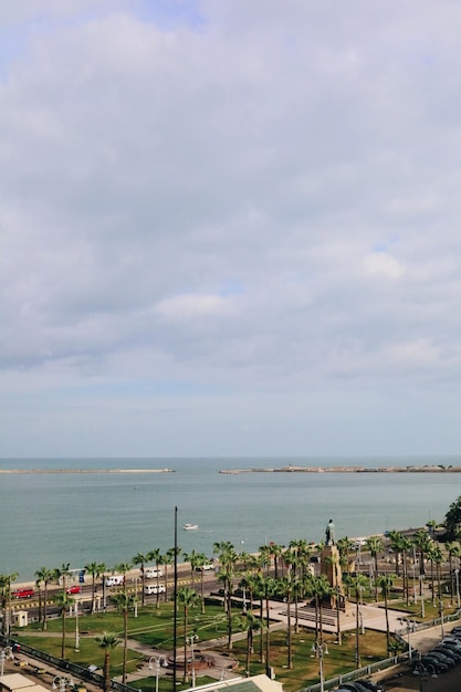 Alexandria, Egypt - 12.11.2021: Mediterranean sea horizon and Alexandria egyptian city view with monument statue of Saad Zaghloul, historical arabic cityscape