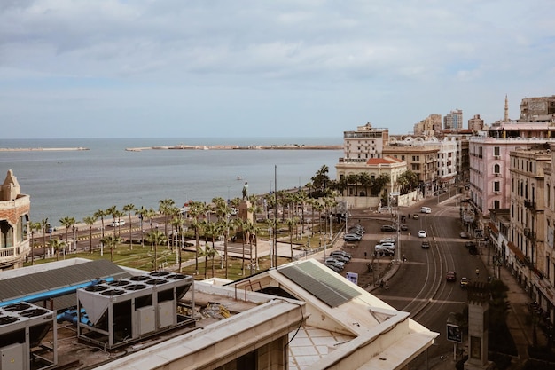 Alexandria, Egypt - 12.11.2021: Old historic buildings rooftops and statue of Saad Zaghloul at main city square