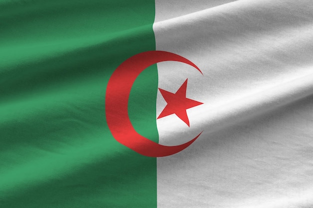 Algeria flag with big folds waving close up under the studio light indoors The official symbols and colors in banner