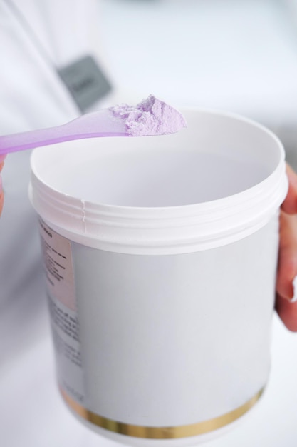 Alginate mask purple in a jar in female hands cosmetic devices for the skin