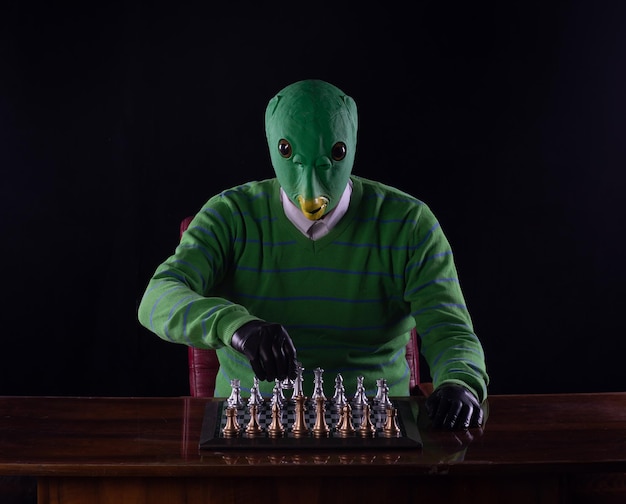 alien playing chess, black studio background