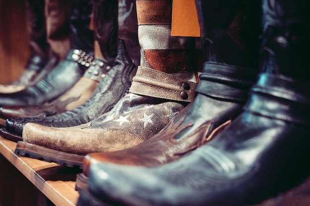 Aligned cowboys boots on a shelf in a store