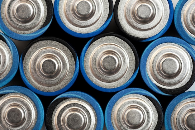 Alkaline batteries stand close to each other and form the background Energy source