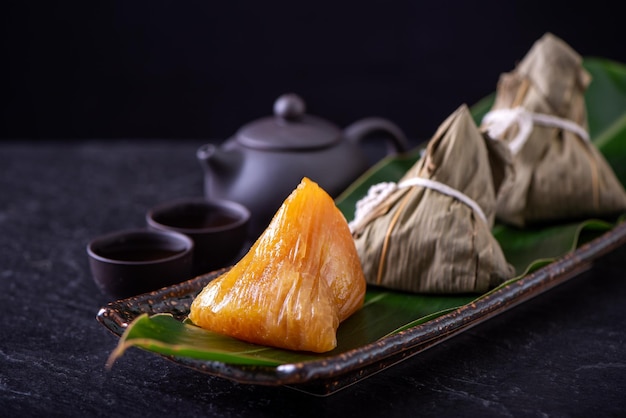 Alkaline rice dumpling zongzi Traditional sweet Chinese crystal food on a plate to eat for Dragon Boat Duanwu Festival celebration concept close up