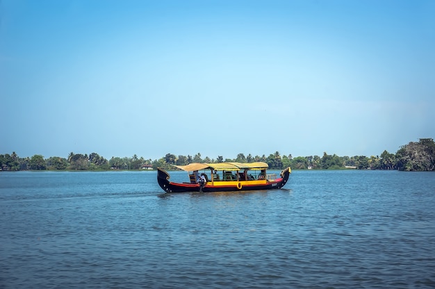 ALLEPPEY, KERALA, INDIA - 15 AUGUST 2010: Unidentified indian people in small boat in backwaters. Kerala backwaters are both major tourist attraction and integral part of local people life in Kerala