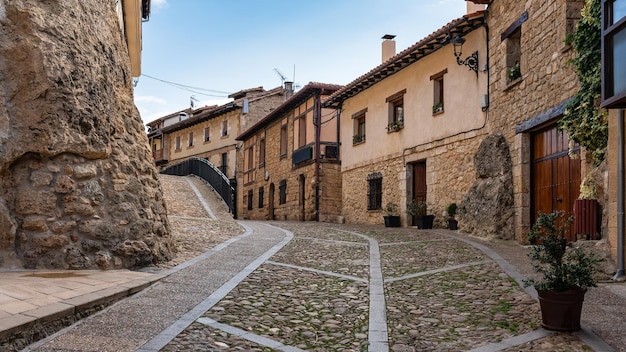 Alley with old houses and cobblestones on the ground in the picturesque village of Frias Burgos Spain