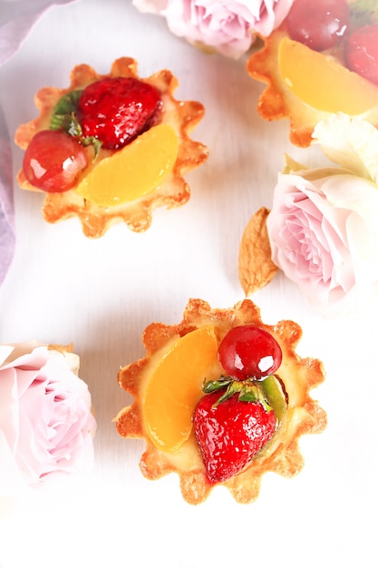 Almond cake with strawberries on a white background selective soft focus