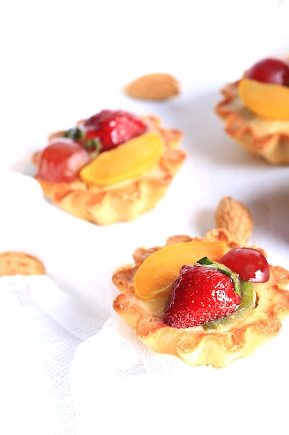 Almond cake with strawberries on a white background selective soft focus