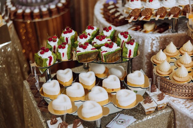 Almond cookies sweet cakes for a wedding banquet A delicious reception a luxurious ceremony Table with sweets and desserts Delicious colorful French desserts on a plate or table Candy bar