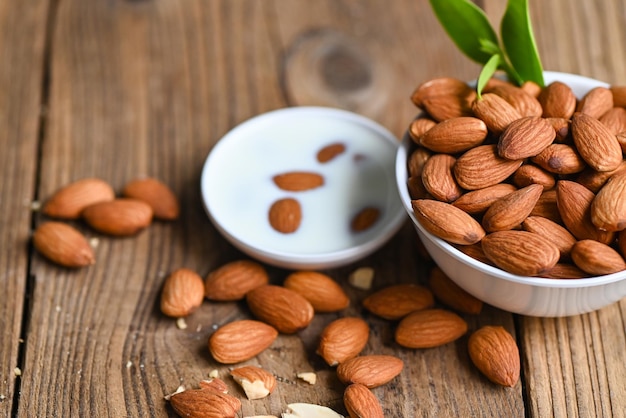 Almond milk and Almonds nuts on on white bowl background Delicious sweet almonds on the table roasted almond nut for healthy food and snack