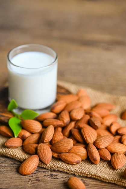 Almond milk and Almonds nuts wooden background Delicious sweet almonds on table roasted almond nut for healthy food and snack