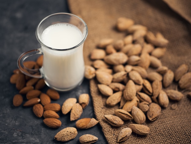 Almond milk . Almonds in a shell on the table