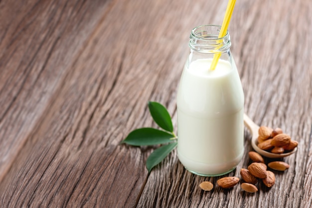 Almond milk in bottle with almonds nut