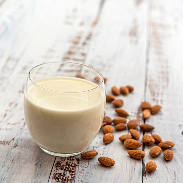 Almond milk in glass with almonds