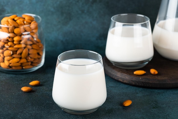 Almond milk with almond on dark background Vegan milk Organic milk