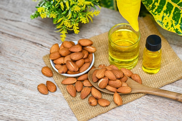 Almond oil and Almonds nuts on table Delicious sweet almonds oil in glass bottle roasted almond nut for healthy food and snack organic vegetable oils for cooking or spa