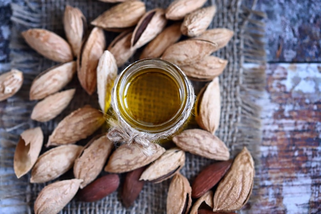 Almond oil in a jar Almonds in shells