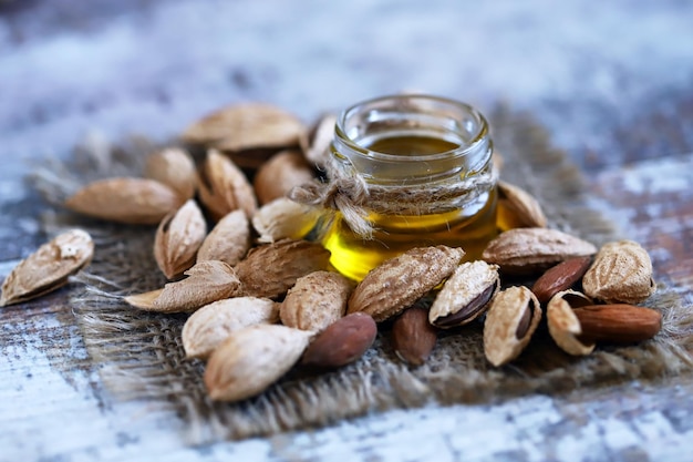 Almond oil in a jar Almonds in shells