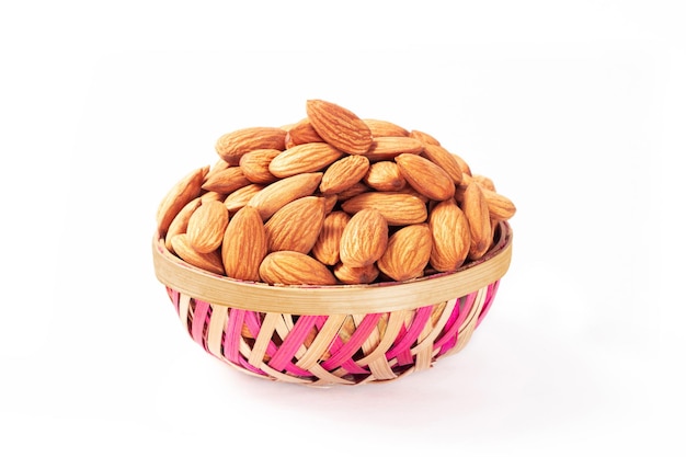 Almonds in bamboo made bowl isolated on white background