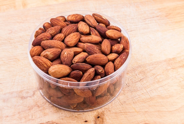 Almonds nuts in plastic bowl