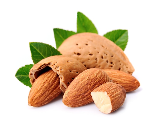 Almonds nuts with leaves on white backgrounds.