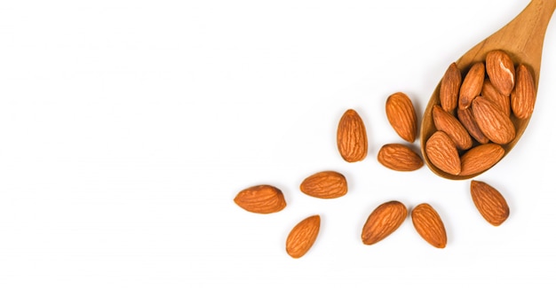 Almonds nuts on wooden spoon / Close up almond isolated on white background