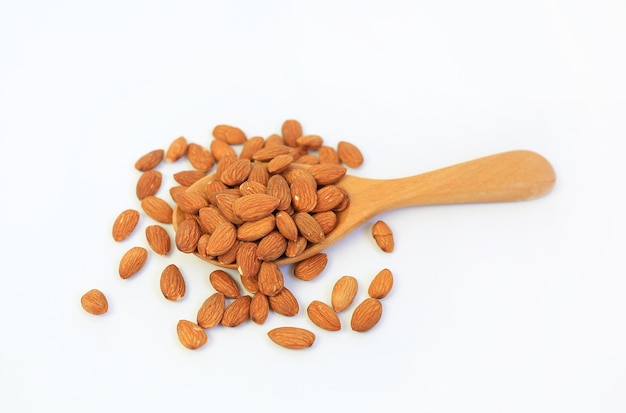 Almonds nuts in wooden spoon isolated on a white background