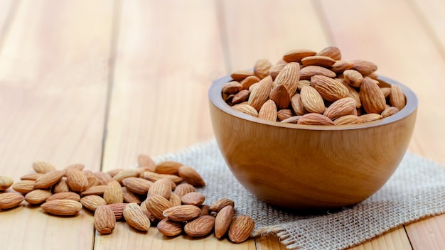 Almonds pour from wood cup