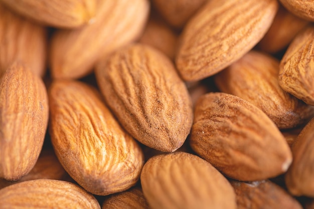 Almonds on a white plate in macro photography.