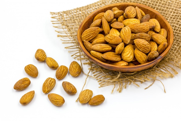 Almonds with bowl on the white background. 