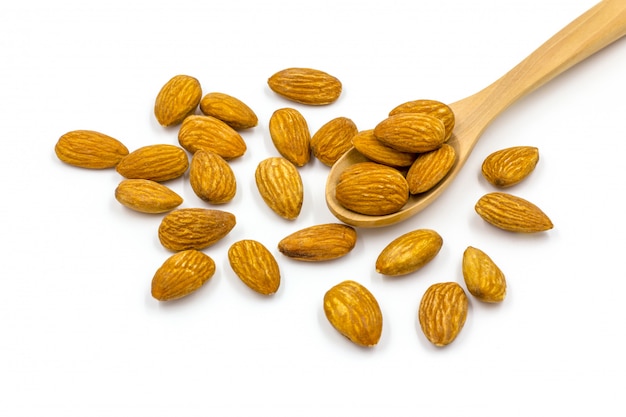 Almonds with wooden spoon on the white background. 