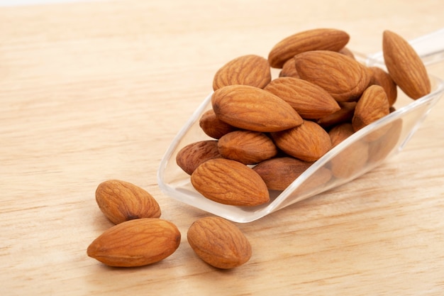 Almonds on wooden background. Healty food concept.