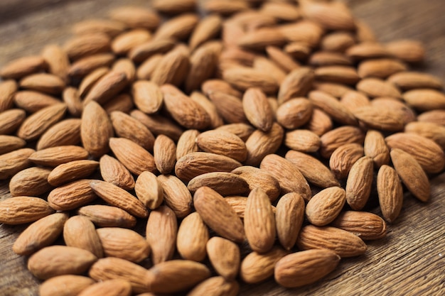 Almonds on wooden background