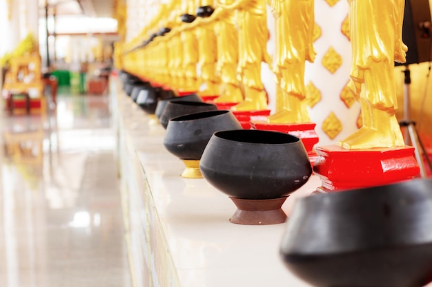 Alms on table in temple of Thailand