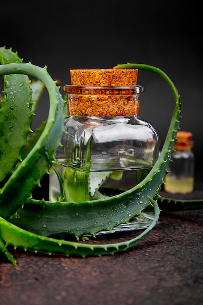 Aloe vera oil in glass bottle and towel for spa